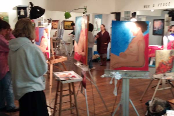 photo of people, easels, artworks