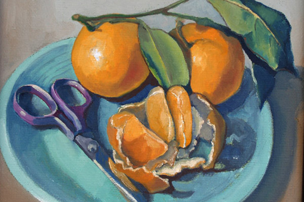 dish with three tangerines and a pair of small scissors